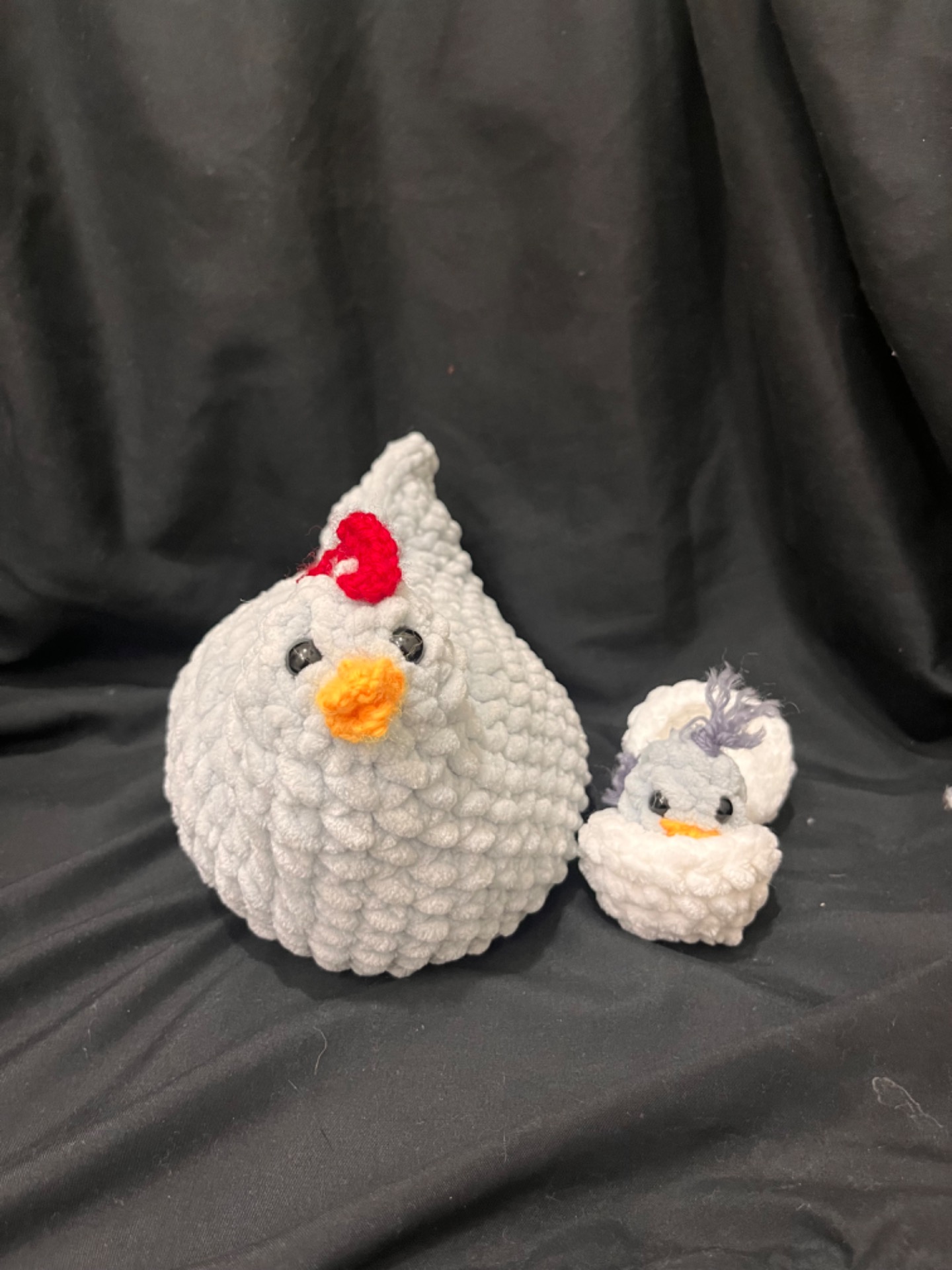 TAP HERE FOR MORE- This is Sweet Peas line of Crocheted Plushies. This is Henny and her baby chick. The hen has a spot under the belly where the egg sits. These are hand made, one of a kind, and super cool. 